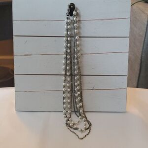 Free with $10 purch necklace pearl silver. 18" it can hook onto pants, shirt...